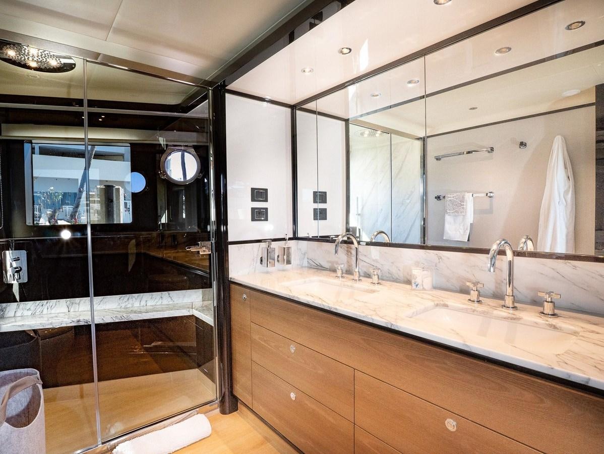 a bathroom with a large mirror aboard POWERSFUL Yacht for Sale