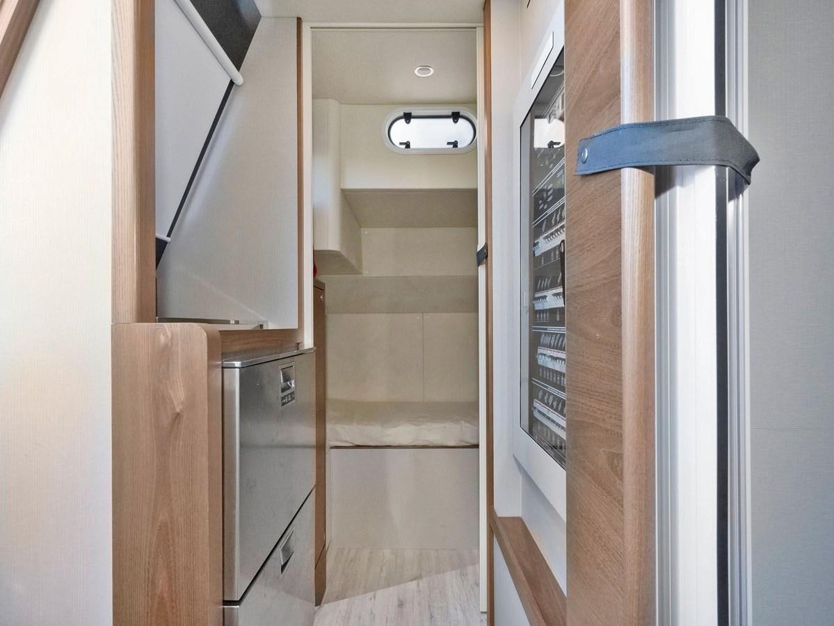 a room with a closet and a shelf with a door aboard POWERSFUL Yacht for Sale