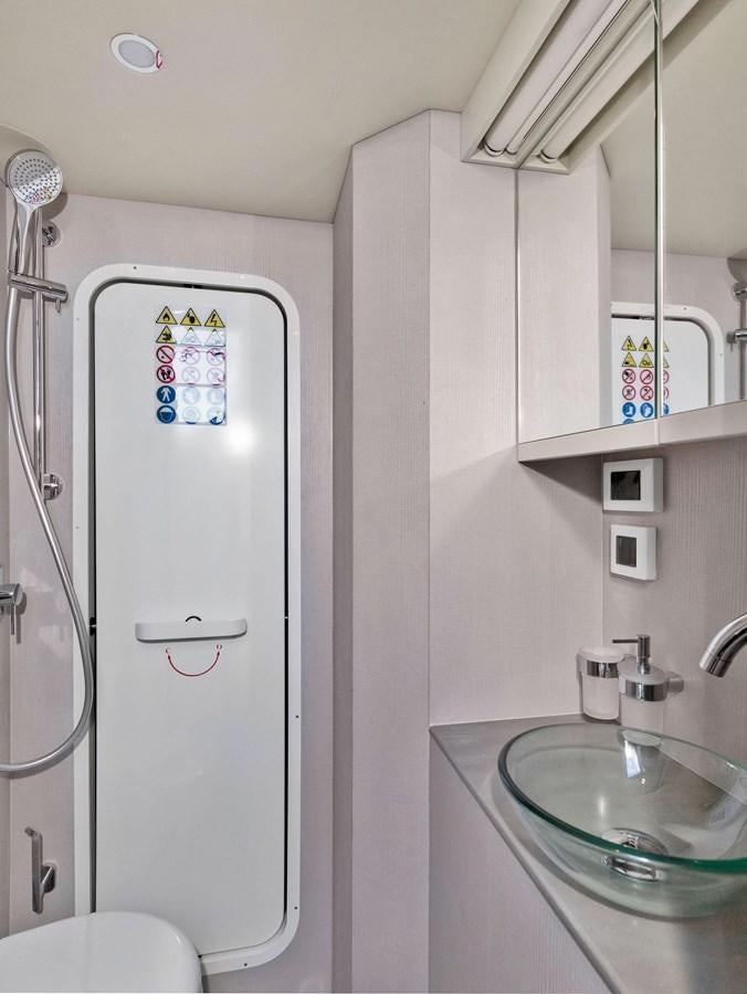 a bathroom with a shower unit aboard POWERSFUL Yacht for Sale