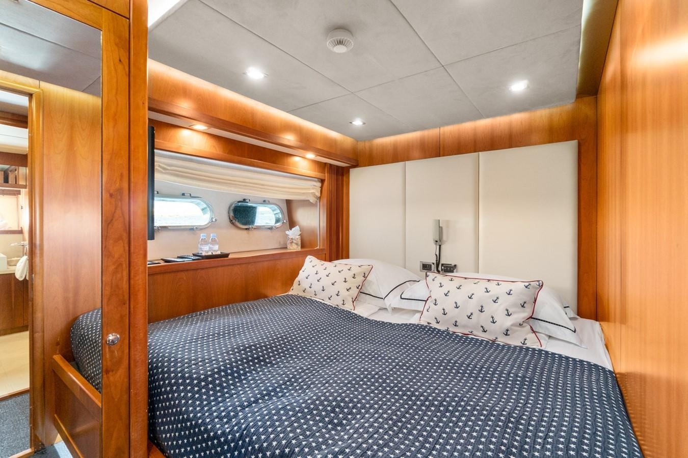 a bed with a mirror above it aboard EYE Yacht for Sale