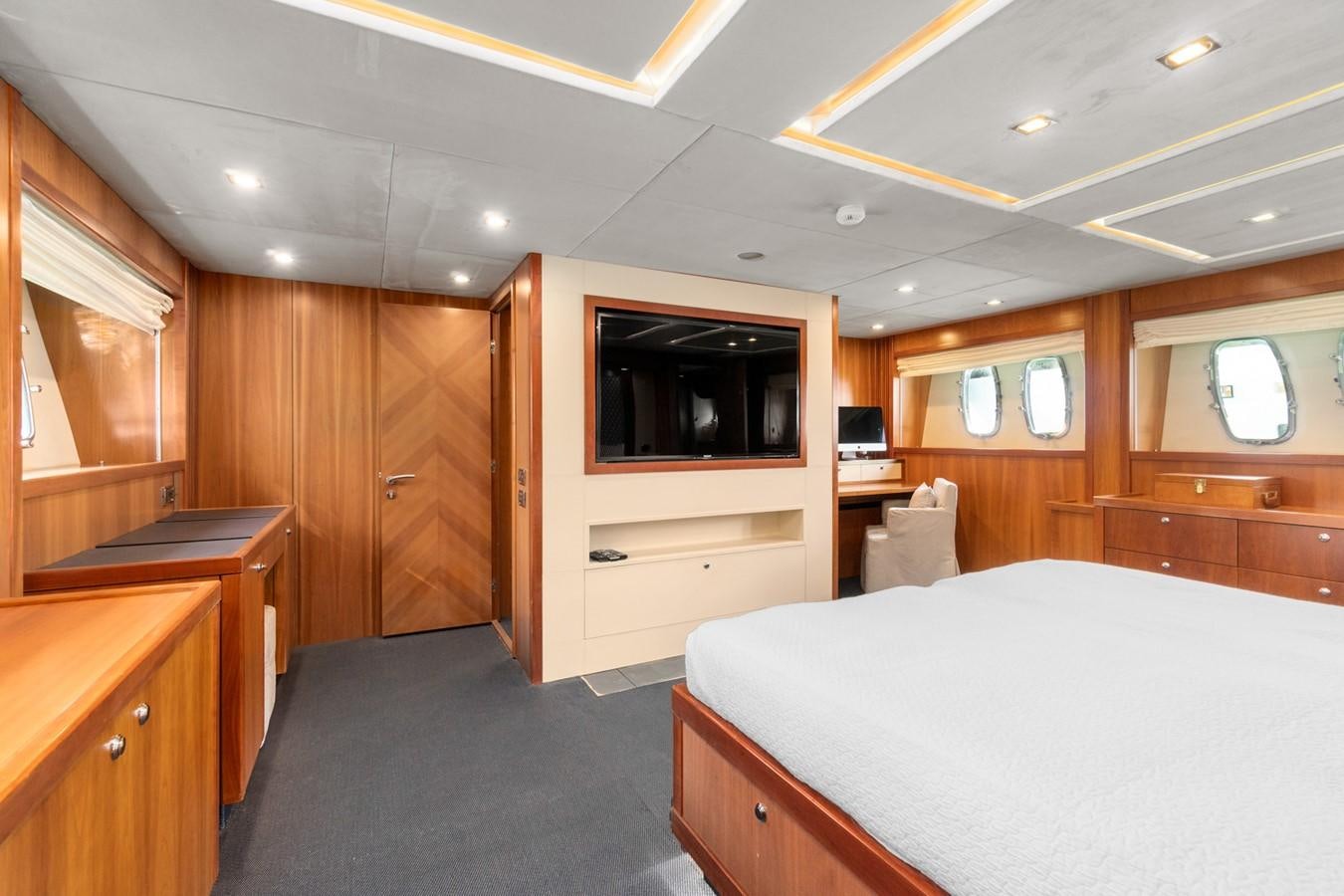 a bedroom with a bed and a television aboard EYE Yacht for Sale