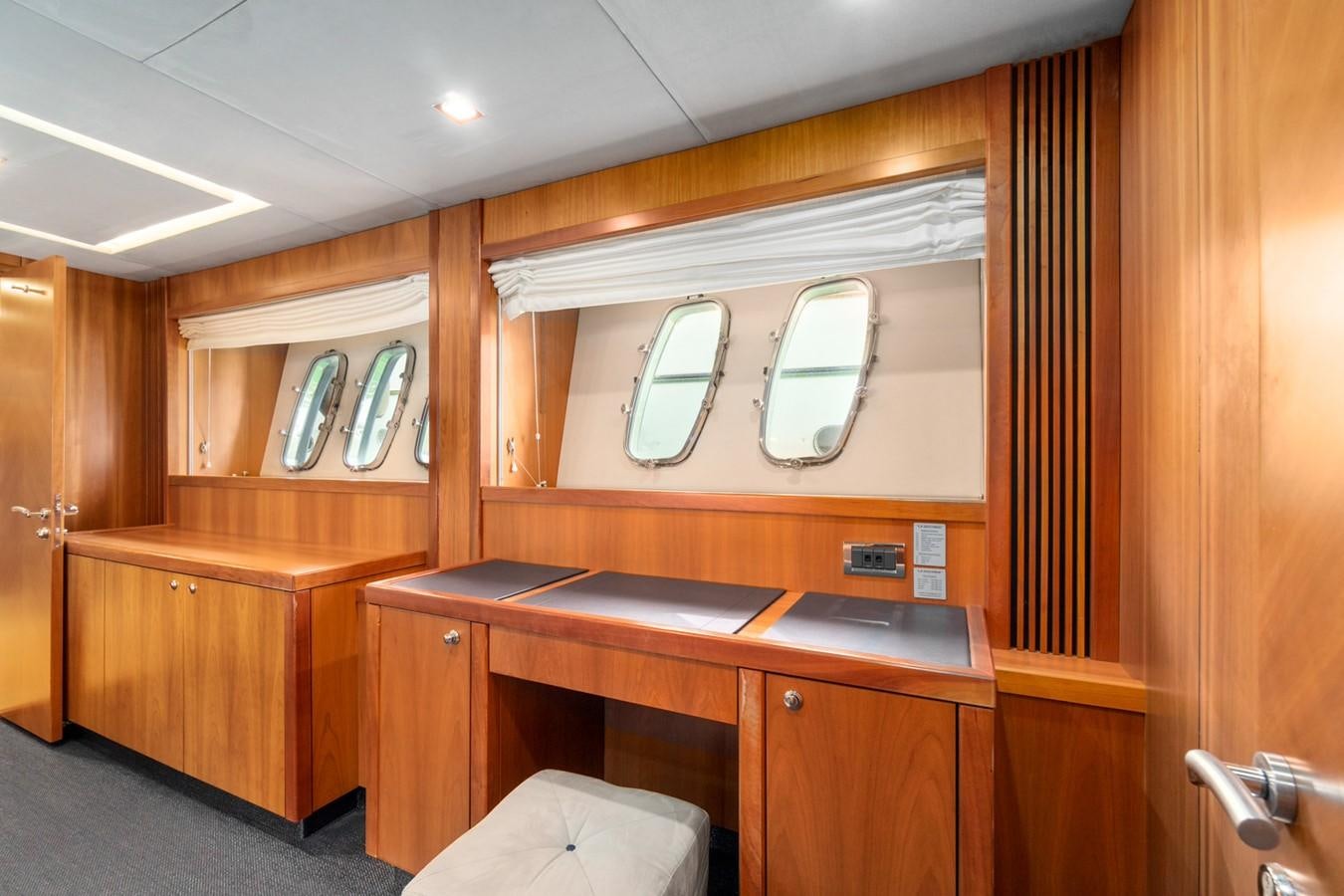 a wooden cabin with a vanity and mirror aboard EYE Yacht for Sale