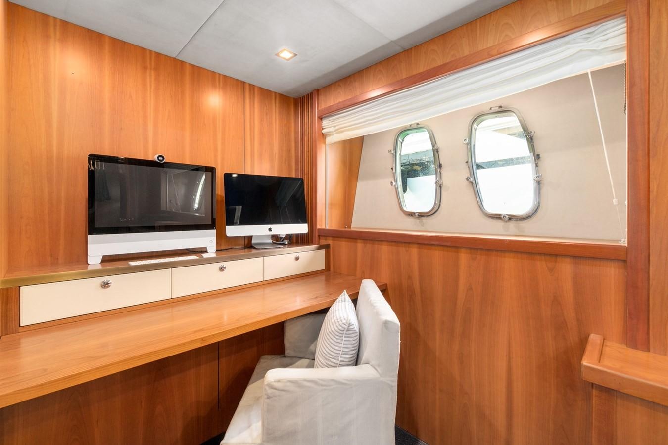 a room with a tv and a chair aboard EYE Yacht for Sale