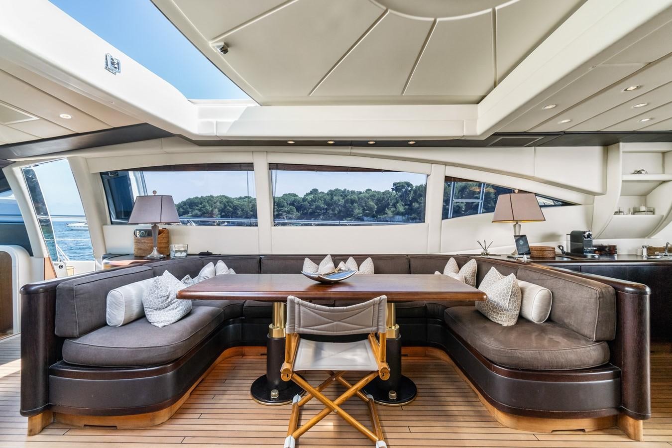 a living room with a couch and a table aboard KUY KUY Yacht for Sale