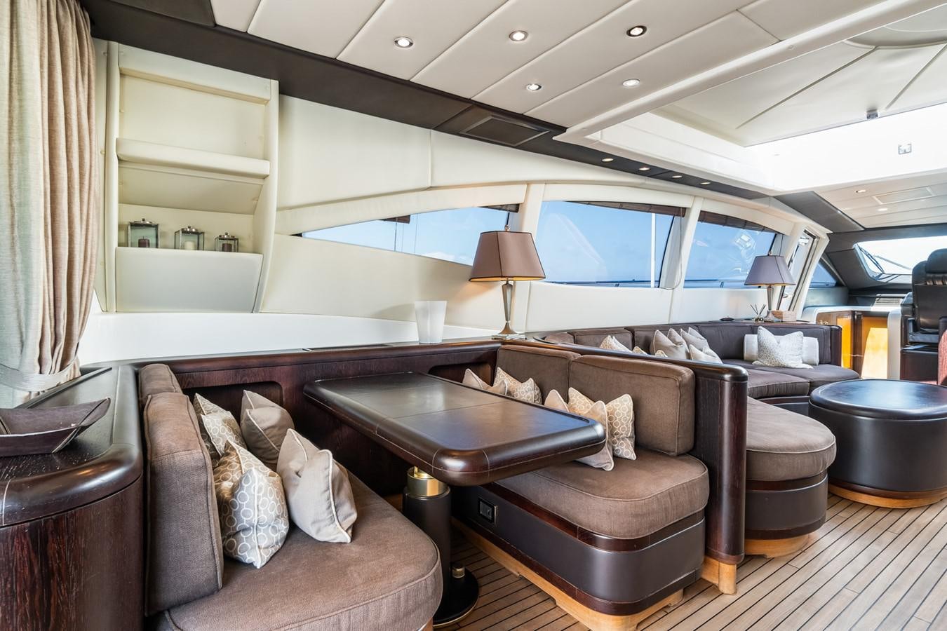 a living room with a leather couch and a large window aboard KUY KUY Yacht for Sale