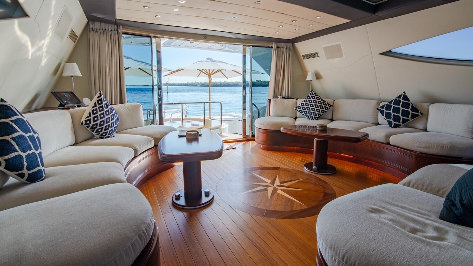 a living room with a large balcony aboard HELLS BELLS Yacht for Sale