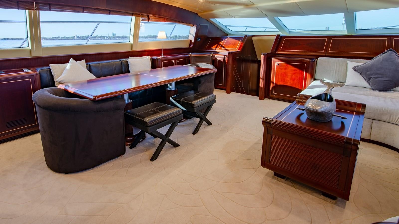 a room with a couch and a table and chairs aboard HELLS BELLS Yacht for Sale