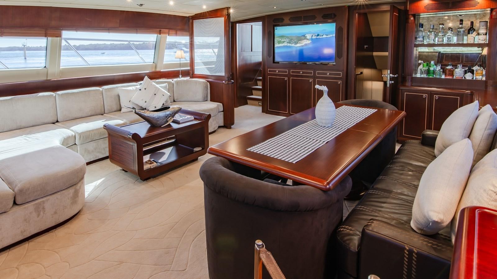a living room with a large tv aboard HELLS BELLS Yacht for Sale