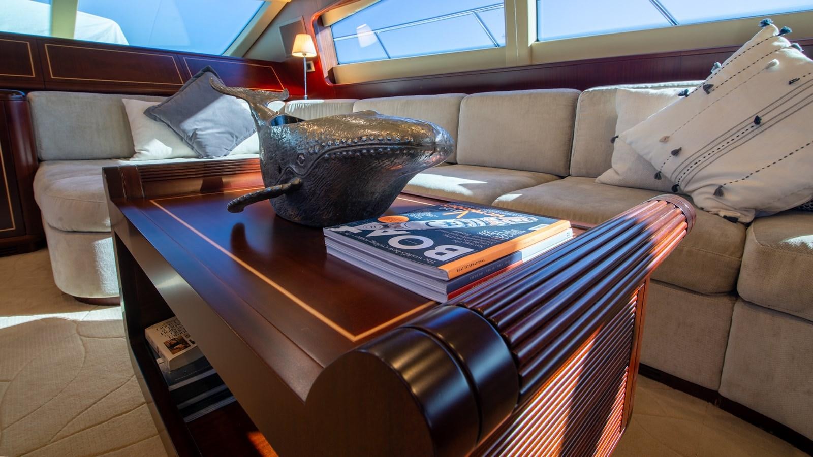 a coffee table with a bowl on it aboard HELLS BELLS Yacht for Sale
