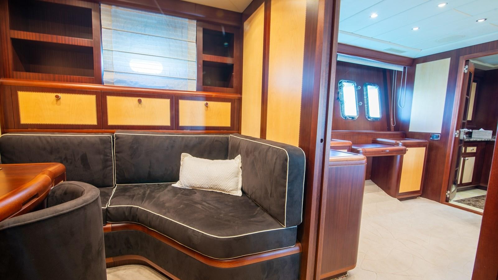 a living room with a leather couch aboard HELLS BELLS Yacht for Sale