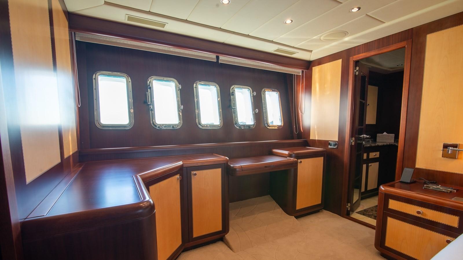 a room with a desk and a window aboard HELLS BELLS Yacht for Sale