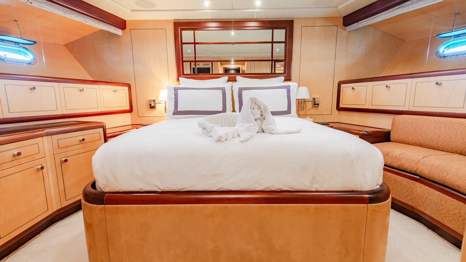 a cat lying on a bed aboard HELLS BELLS Yacht for Sale