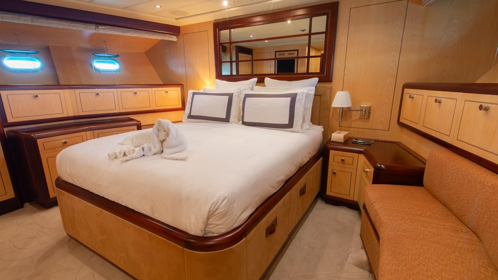 a room with a bed and a couch aboard HELLS BELLS Yacht for Sale