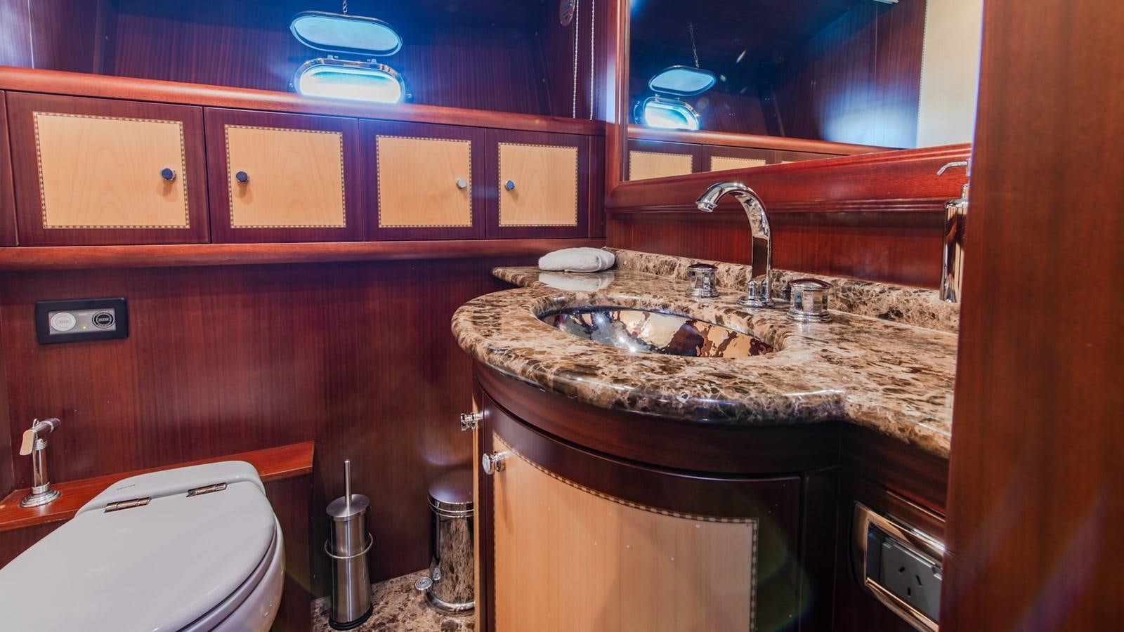 a bathroom with a sink and a toilet aboard HELLS BELLS Yacht for Sale
