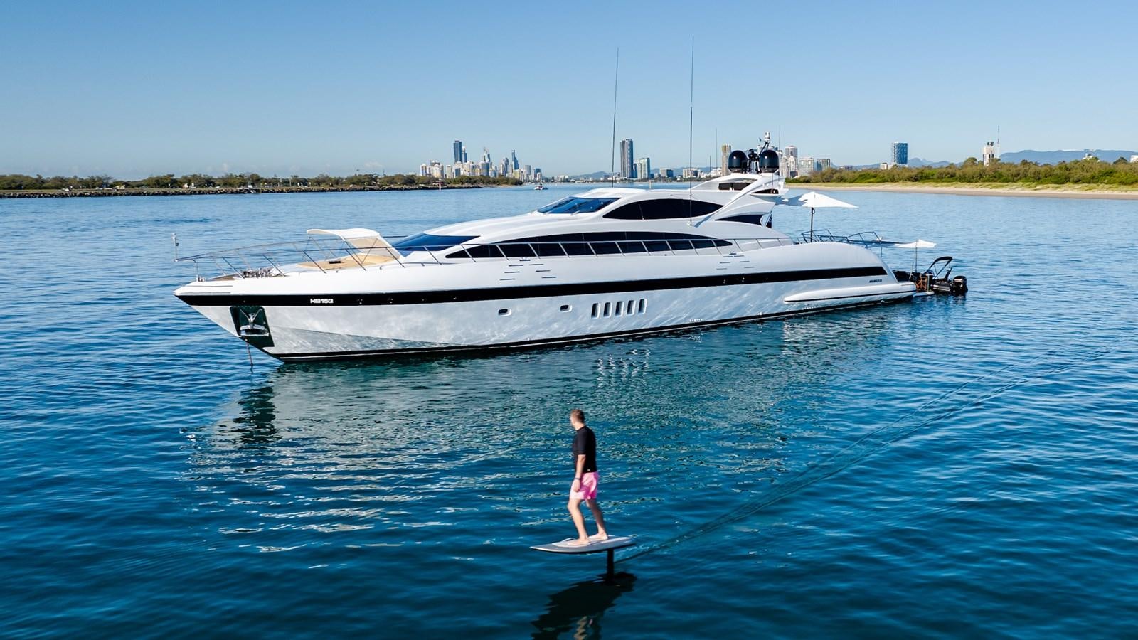 a person standing in front of a white boat aboard HELLS BELLS Yacht for Sale