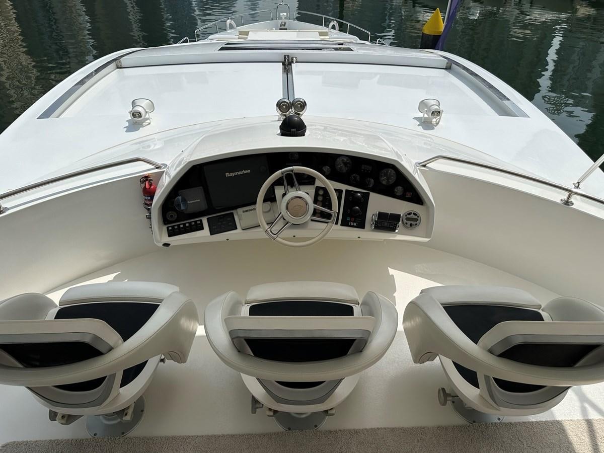 a white car with a black tire aboard MANIA Yacht for Sale