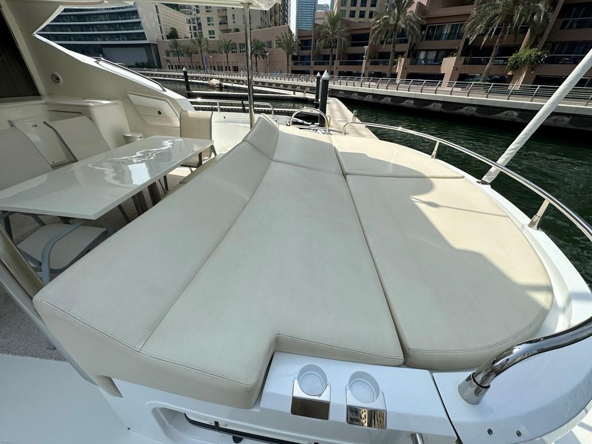 a white boat on a dock aboard MANIA Yacht for Sale