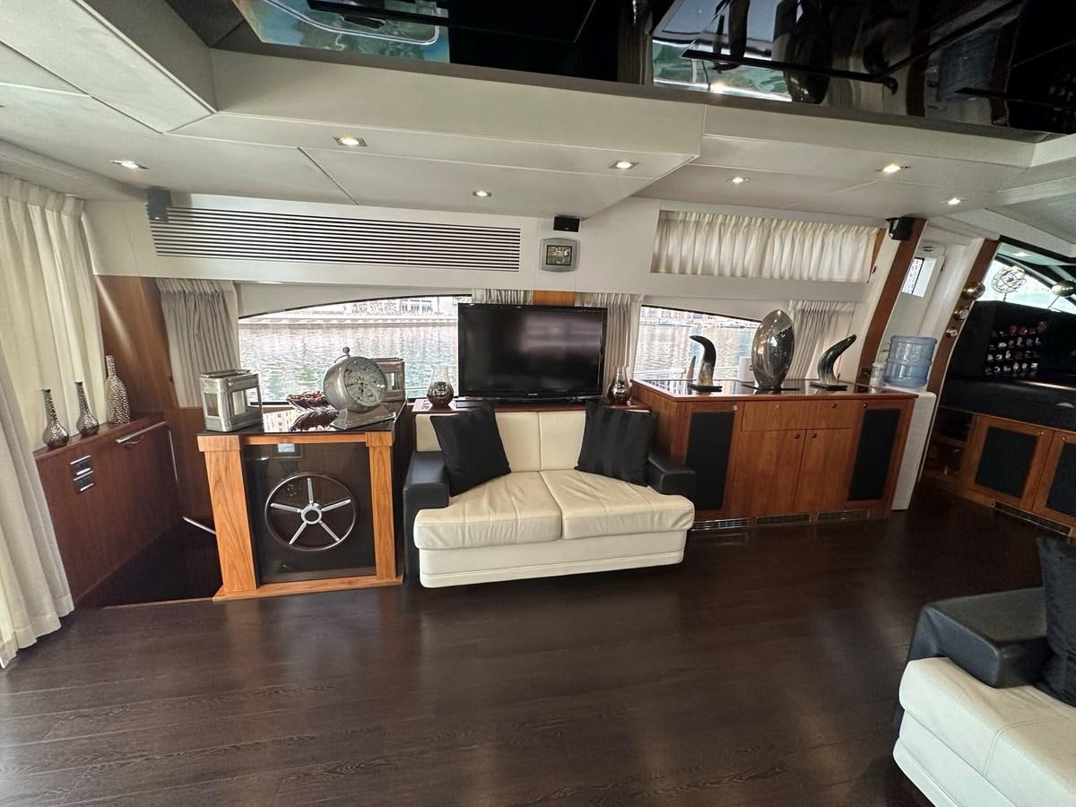 a room with a couch and a tv aboard MANIA Yacht for Sale