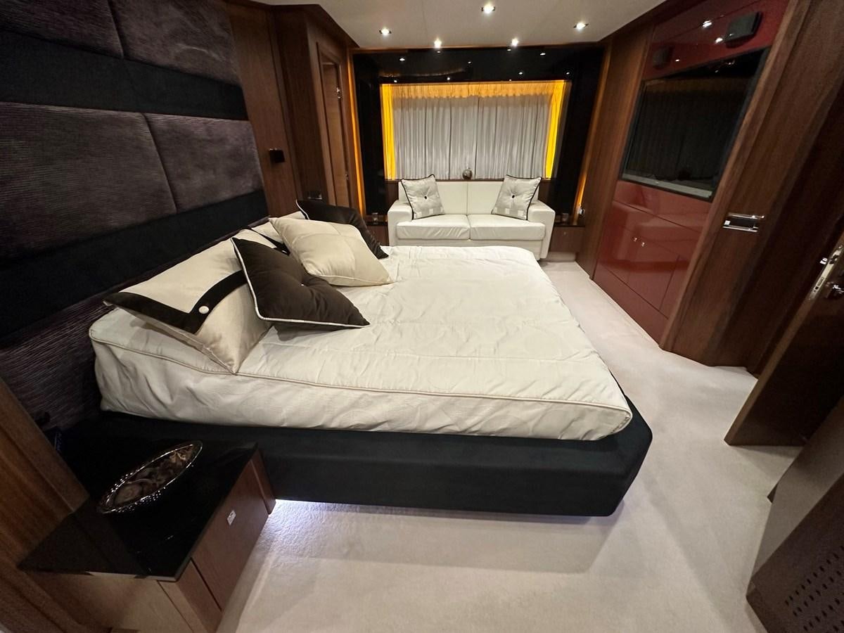 a room with a bed and a chair aboard MANIA Yacht for Sale
