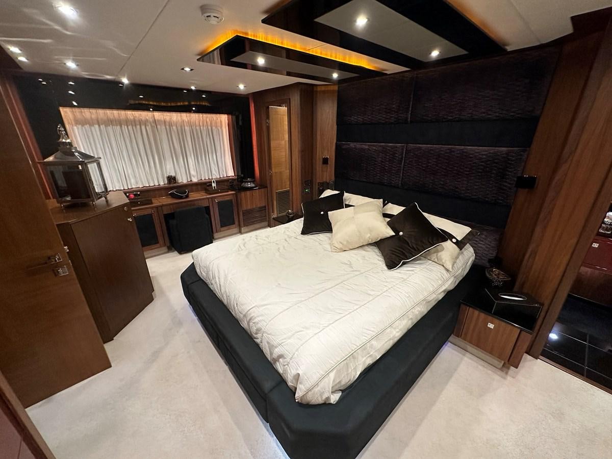 a room with a bed and a television aboard MANIA Yacht for Sale