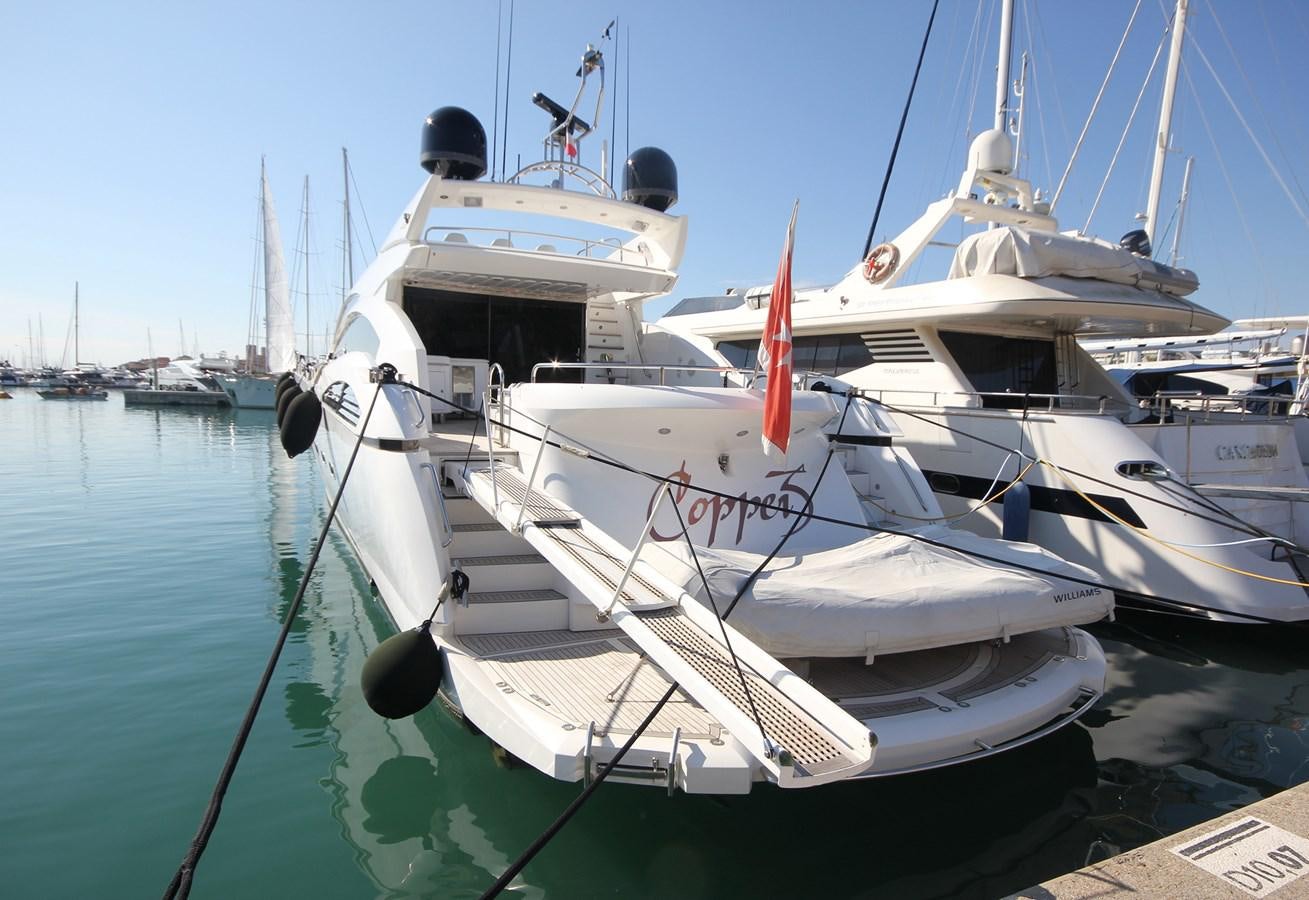 a boat docked in a harbor aboard COPPER 3 Yacht for Sale