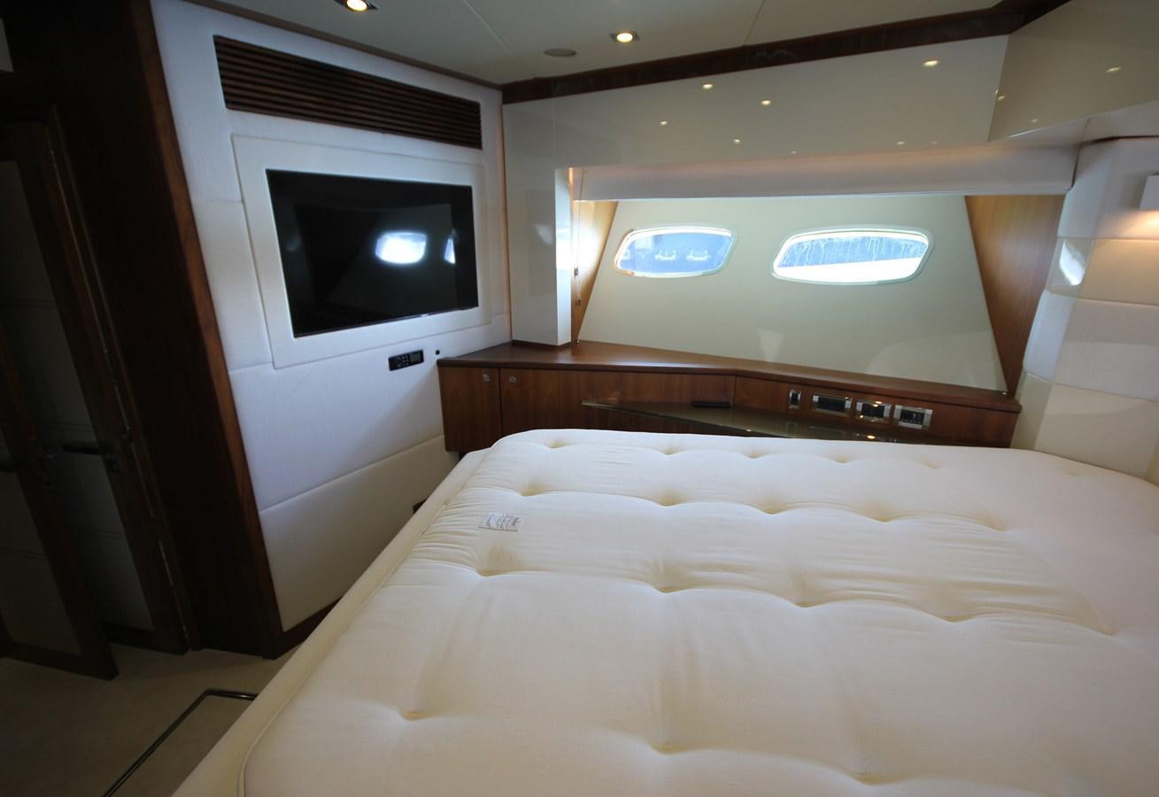 a bed with a television on the wall aboard COPPER 3 Yacht for Sale