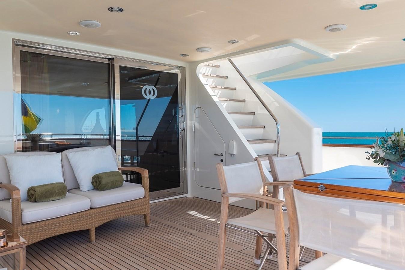 a room with a couch and a table and a window aboard CIAO Yacht for Sale