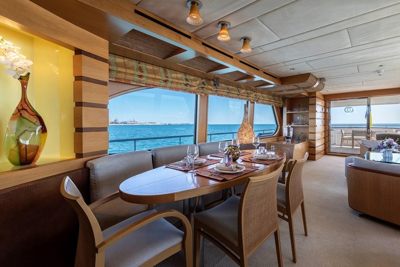 a dining room with a large window aboard CIAO Yacht for Sale
