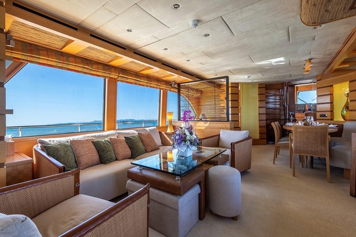 a living room with a couch and a table aboard CIAO Yacht for Sale