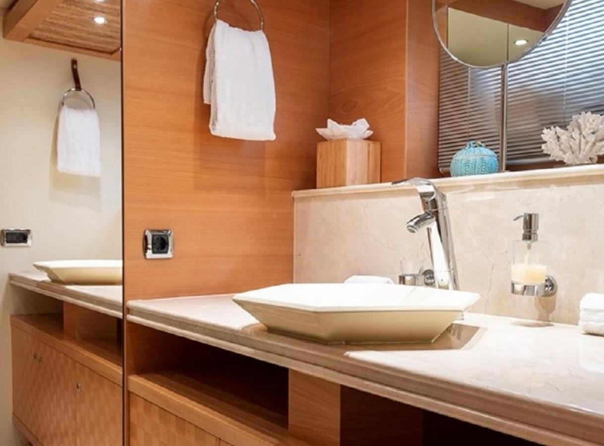 a bathroom with a sink and a mirror aboard CIAO Yacht for Sale