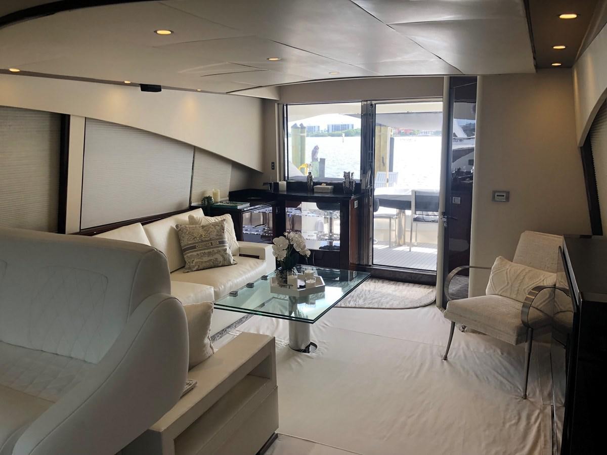 a living room with a glass table aboard BG Yacht for Sale