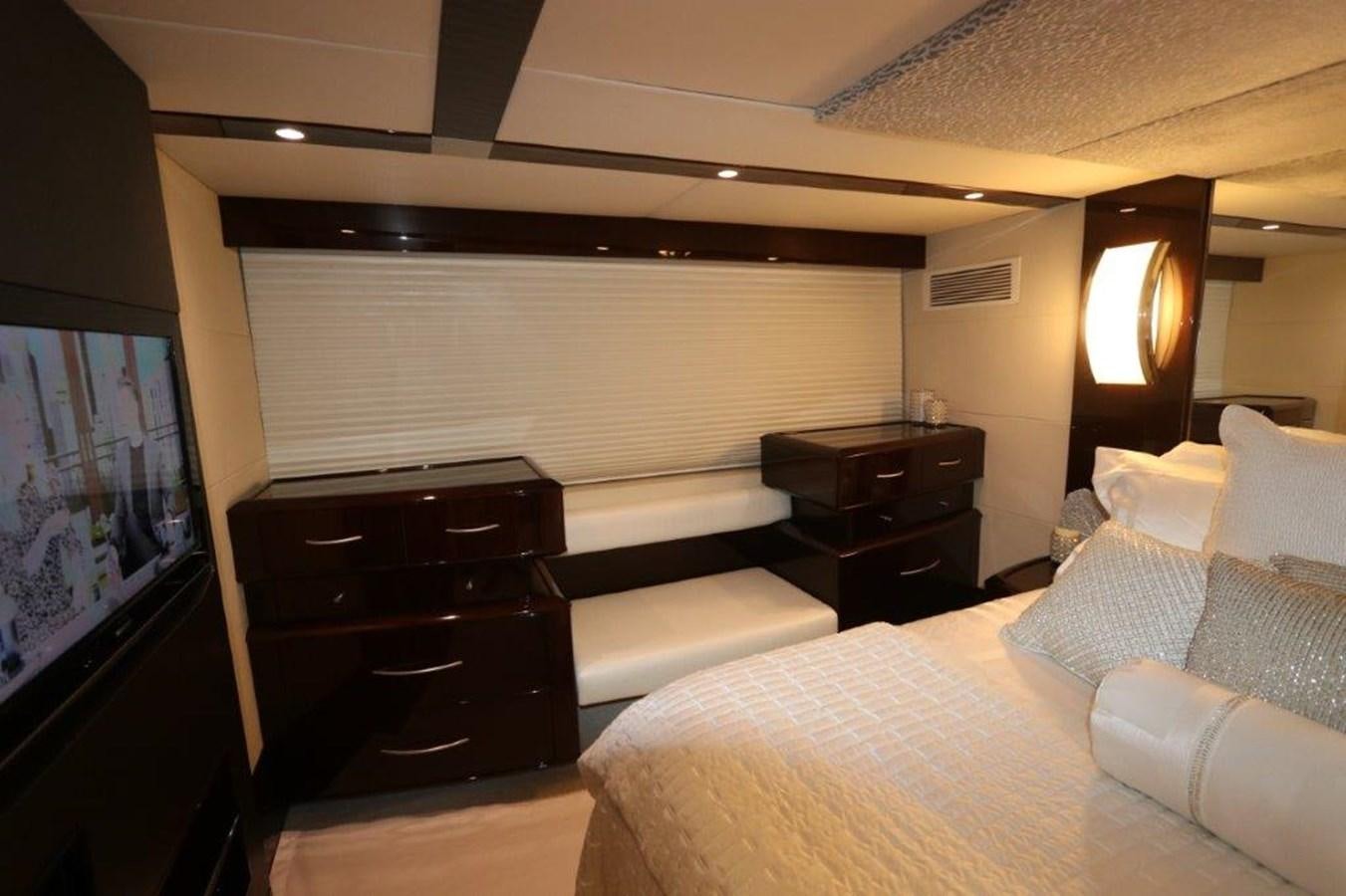 a bedroom with a bed and a television aboard BG Yacht for Sale