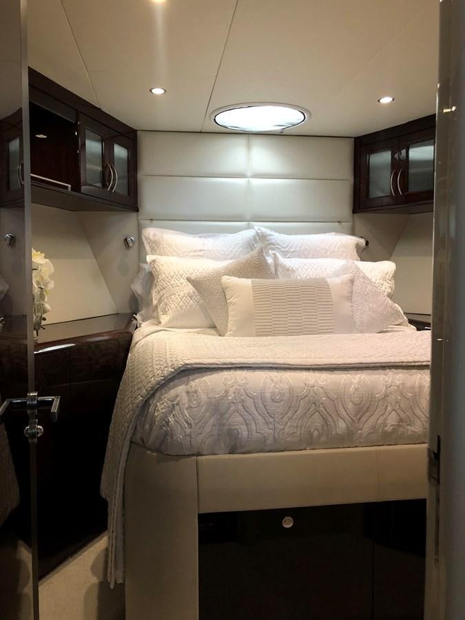 a bed with white sheets aboard BG Yacht for Sale