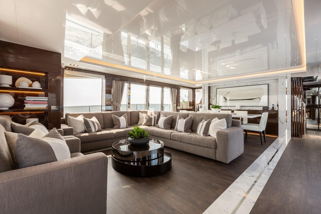 a living room with a couch and a coffee table aboard THETIS Yacht for Sale