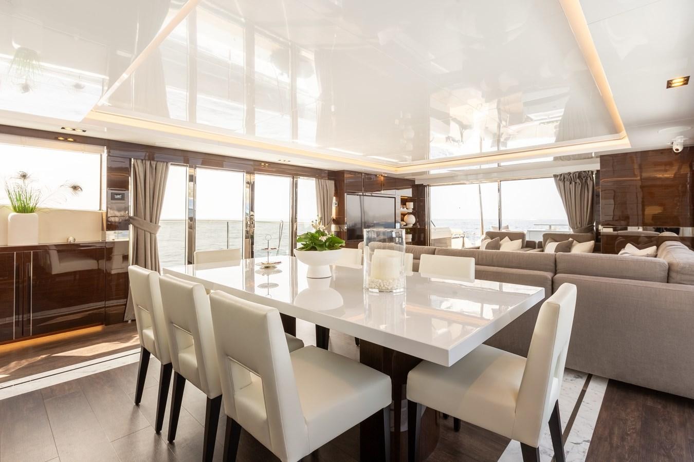a room with a table chairs and a couch aboard THETIS Yacht for Sale