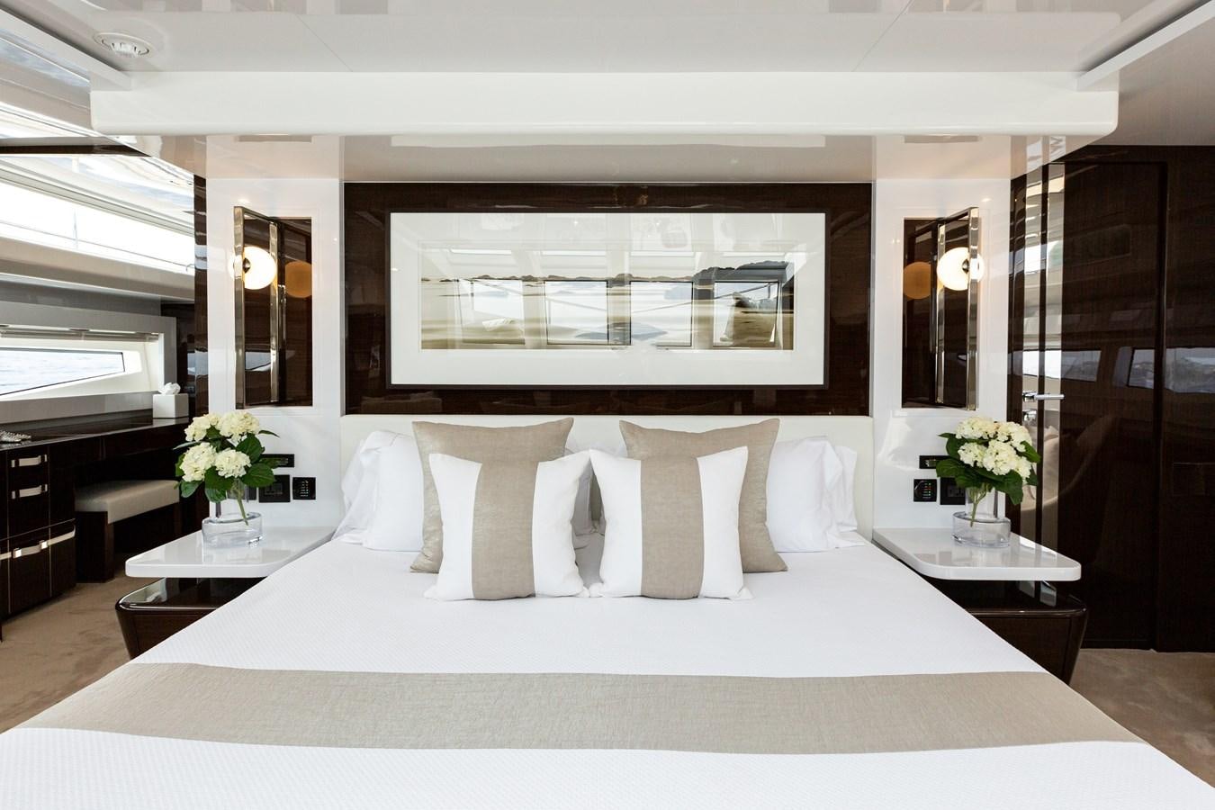 a bed with white sheets and pillows aboard THETIS Yacht for Sale