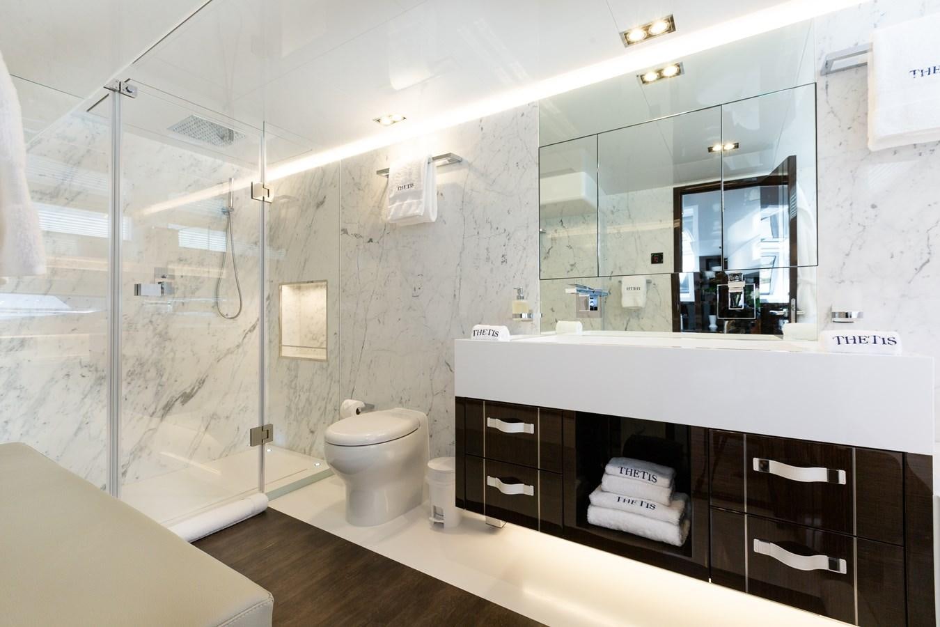a bathroom with a glass shower aboard THETIS Yacht for Sale
