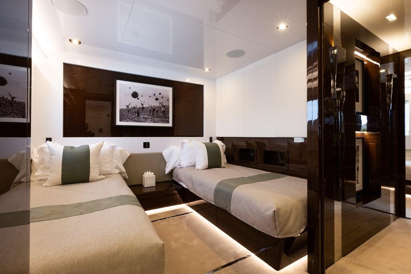a room with a bed and a mirror aboard THETIS Yacht for Sale