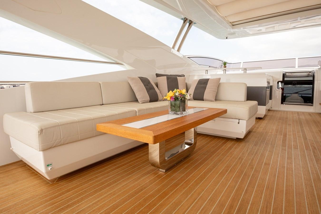 a living room with a couch and a coffee table aboard THETIS Yacht for Sale