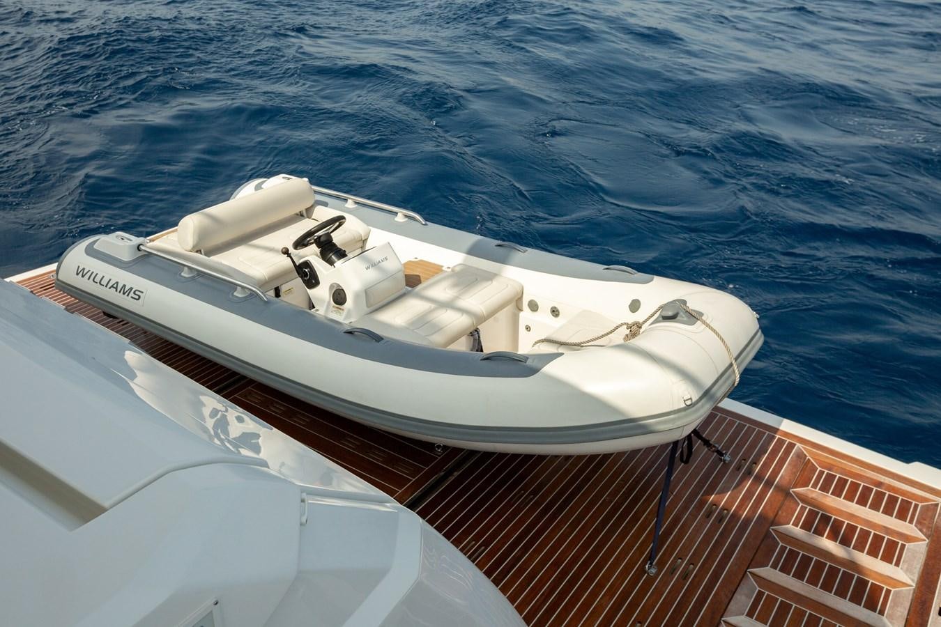 a white boat on the water aboard THETIS Yacht for Sale
