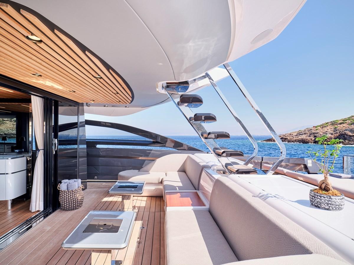 a large white lounge chair on a deck overlooking a large body of water aboard D FIVE Yacht for Sale