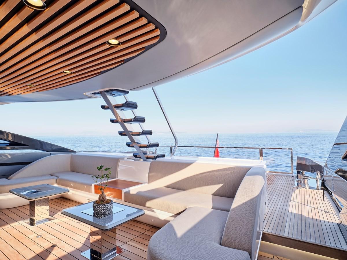 a lounge area with a table and a view of the ocean aboard D FIVE Yacht for Sale
