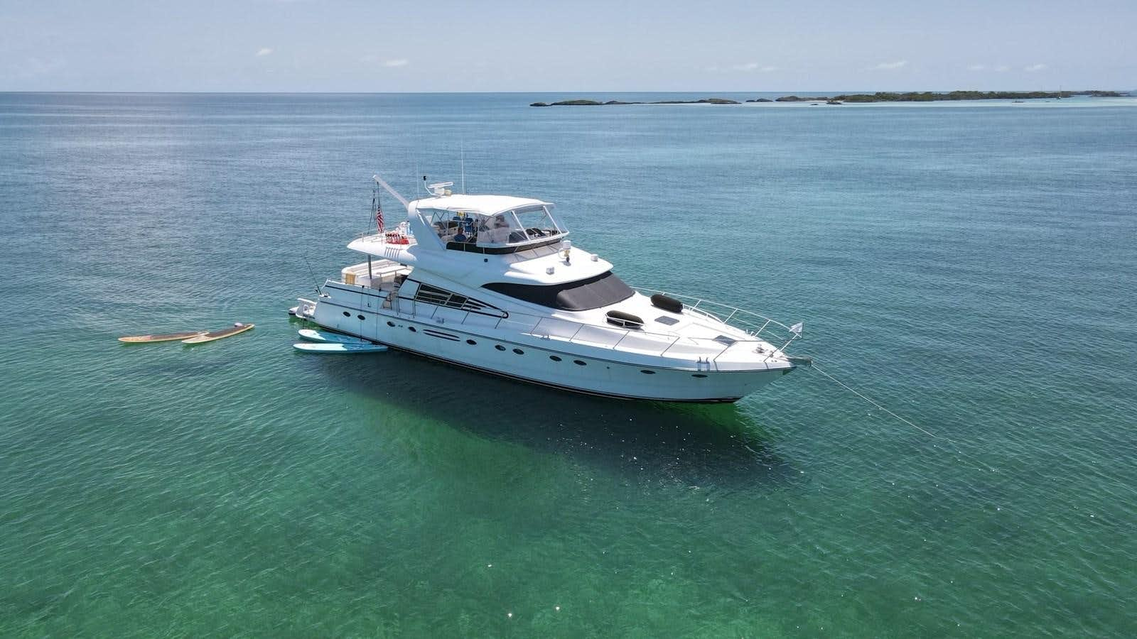 a white boat in the water aboard MADNESS Yacht for Sale