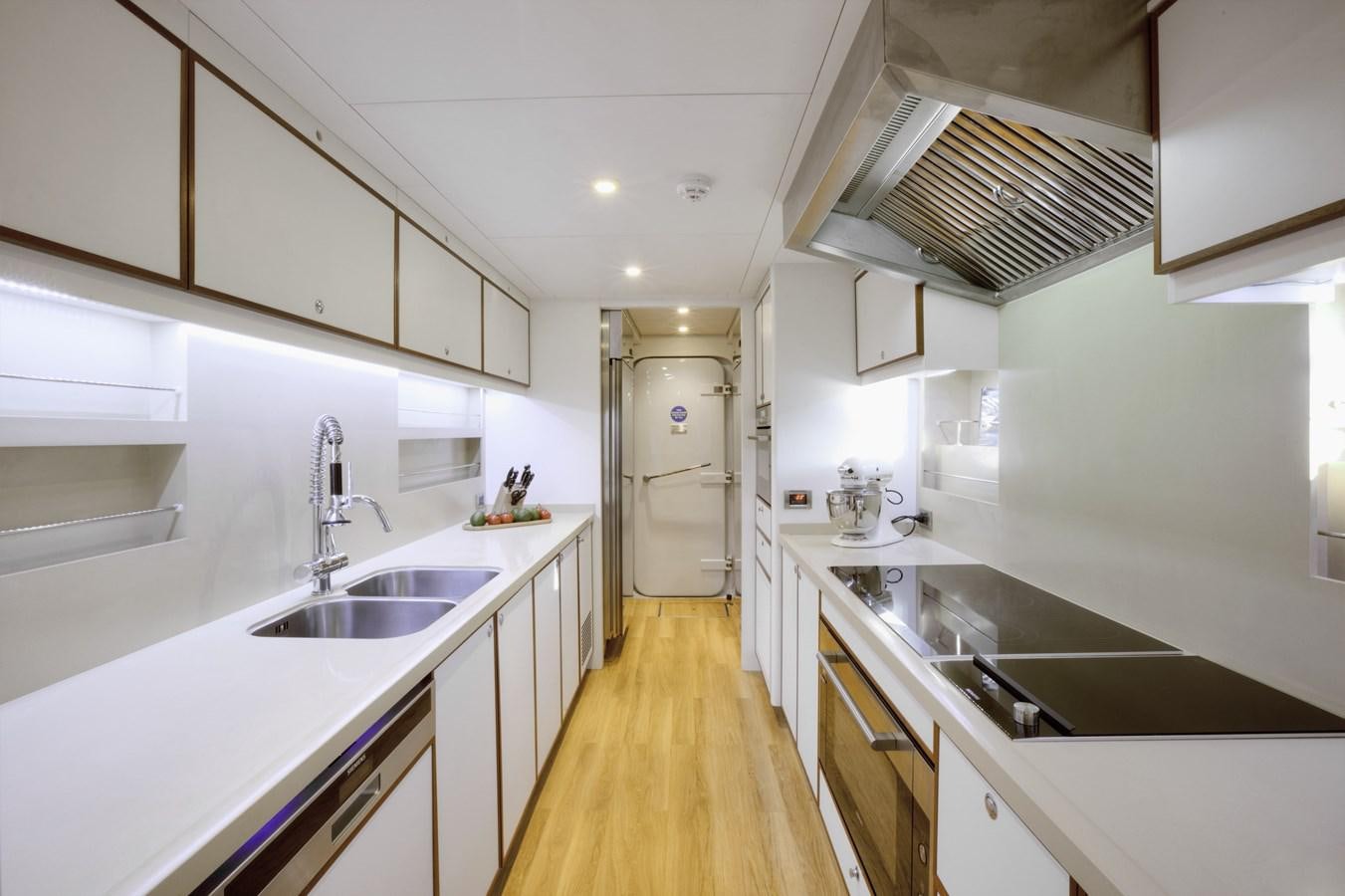 a kitchen with white cabinets aboard SHU U RITE Yacht for Sale