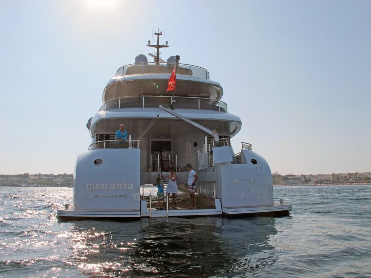 a large white boat in the water with Thomas Point Shoal Light in the background aboard SHU U RITE Yacht for Sale