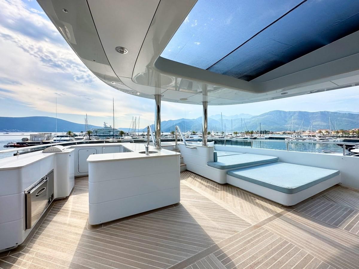 a large white lounge chair on a deck overlooking a large body of water aboard SHU U RITE Yacht for Sale