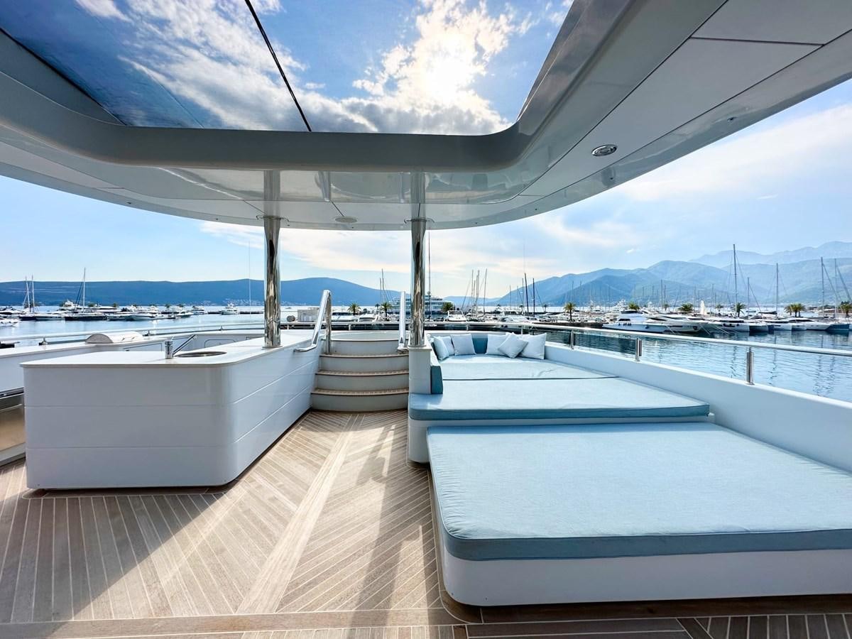 a deck with a view of the water and boats aboard SHU U RITE Yacht for Sale