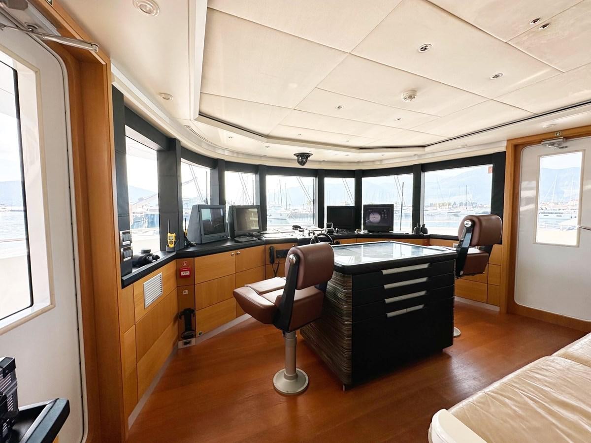 a room with a piano and a chair aboard SHU U RITE Yacht for Sale