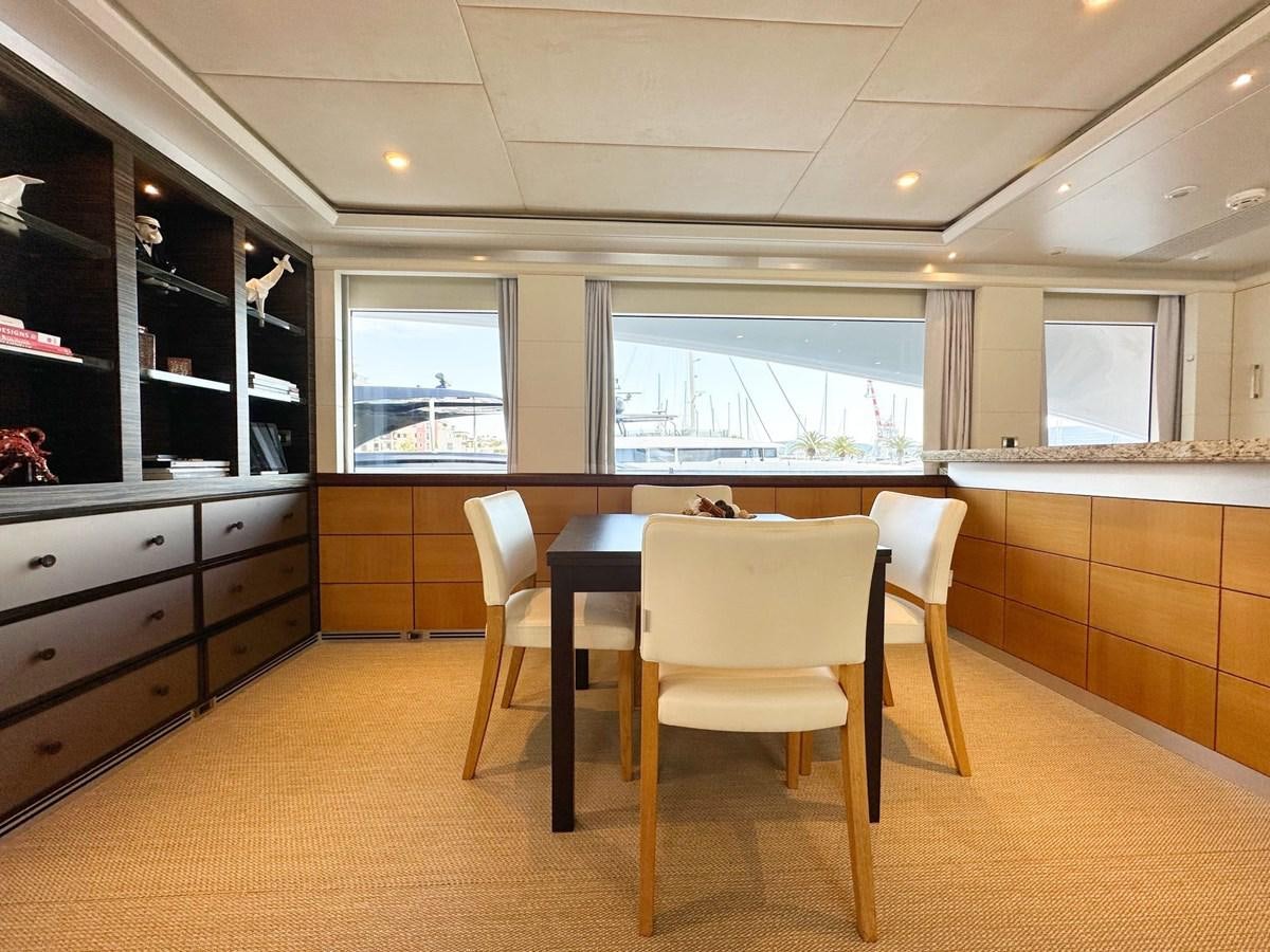a kitchen with a table and chairs aboard SHU U RITE Yacht for Sale