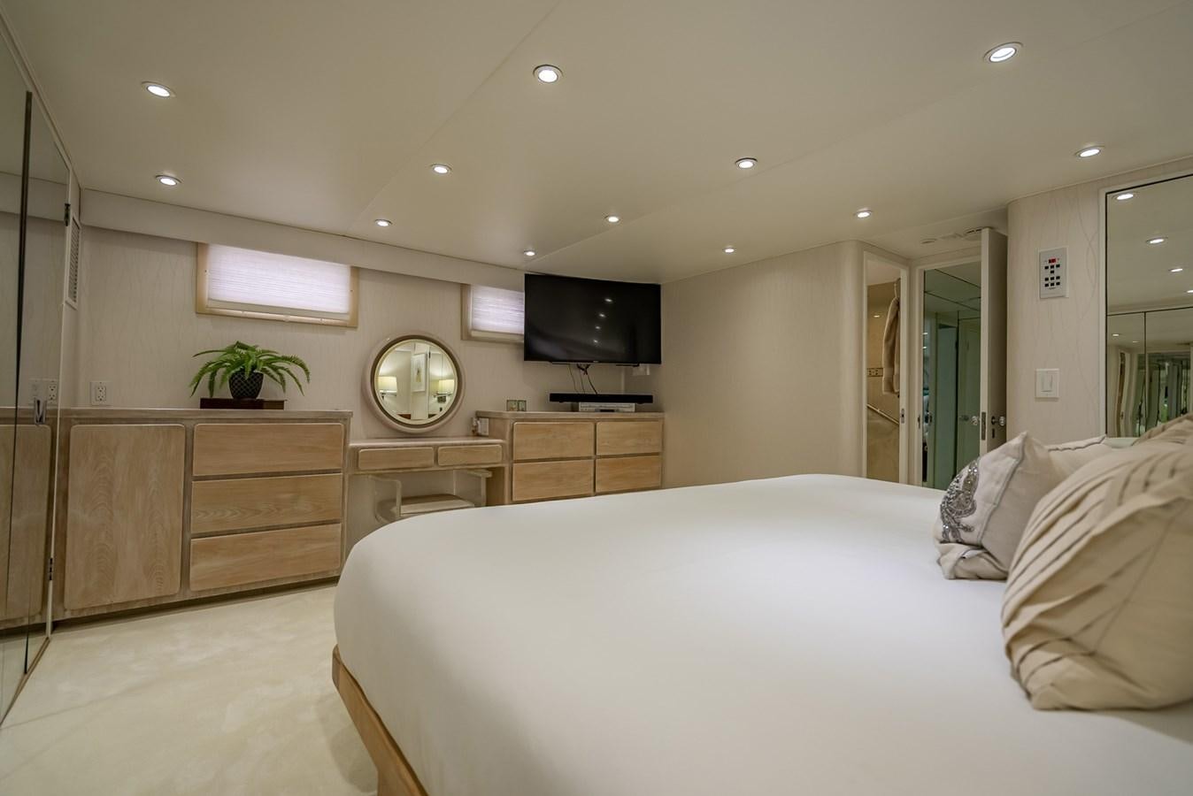 a bedroom with a bed and a tv on the wall aboard MY WAY Yacht for Sale